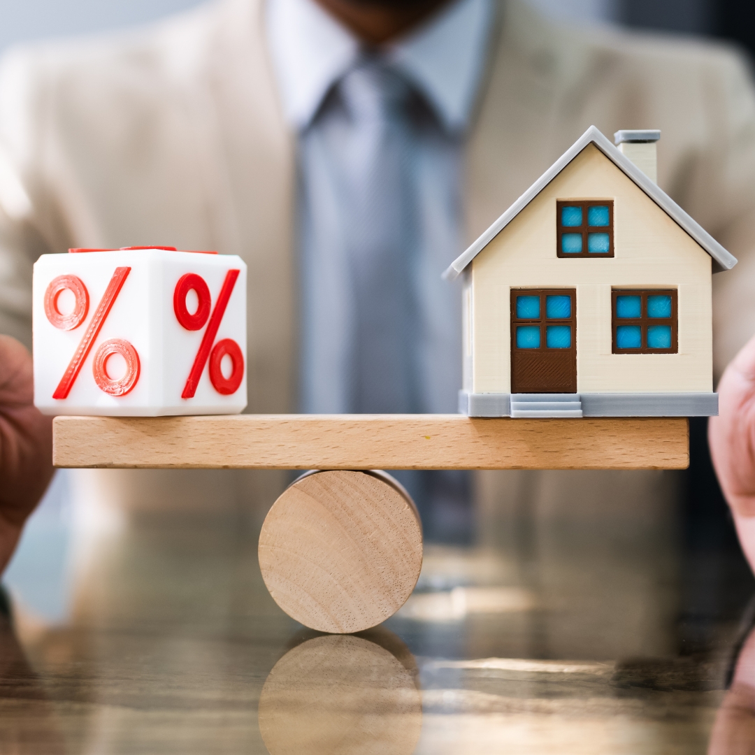 Scale with interest rates on one end and houses on the other